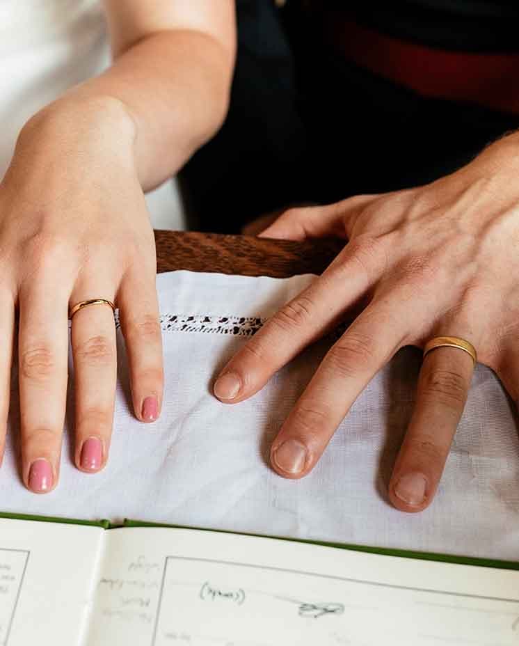 Couple's hands with rings on it on wedding day during ceremony 