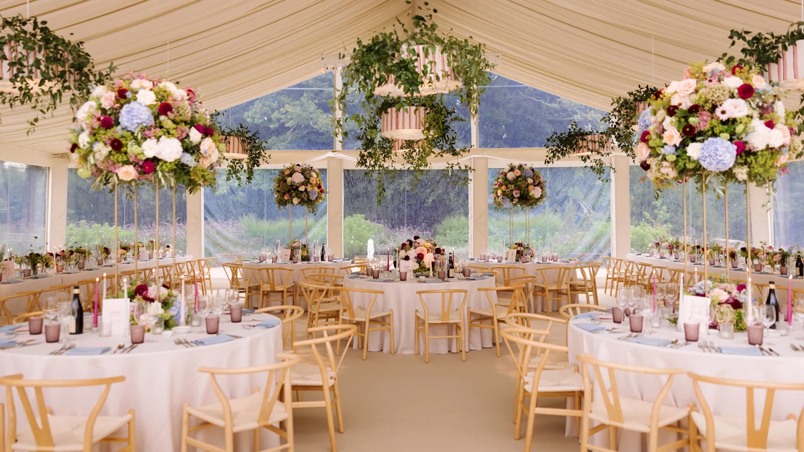 Wedding marquee with circular table seating and floral decor