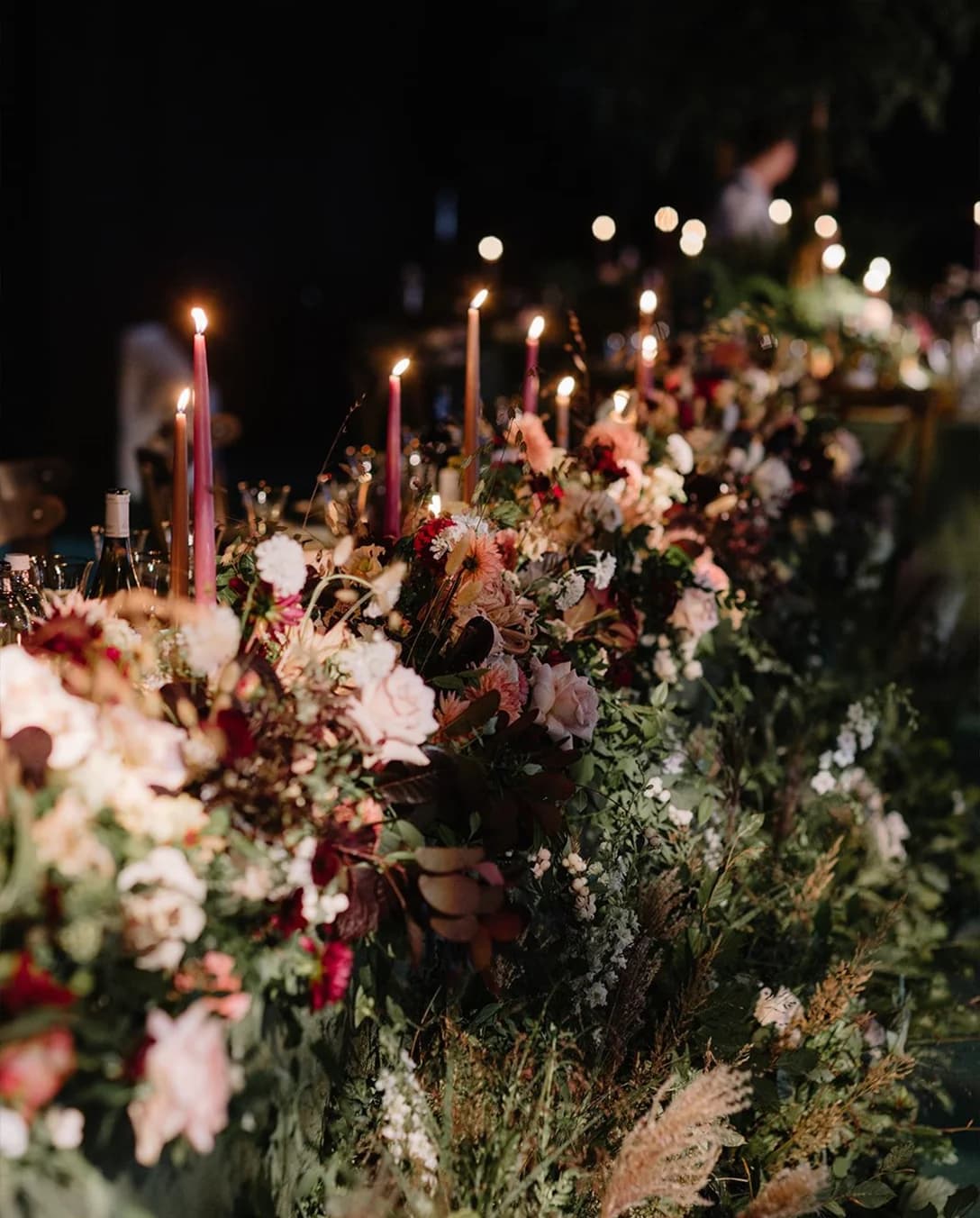 Secret Garden themed floral decor with candles, inside a wedding marquee at Euridge Manor