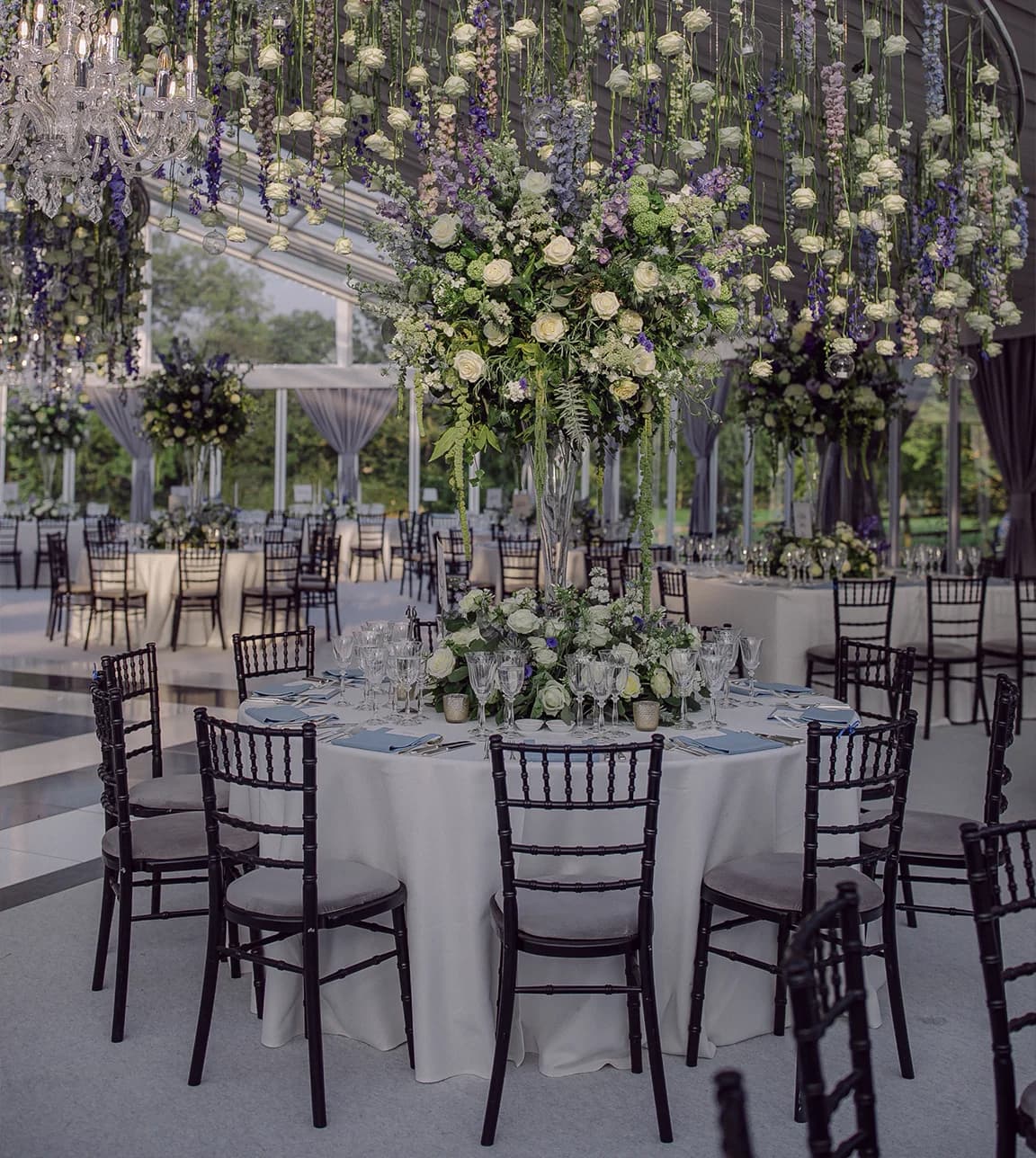 Opulent art-deco marquee wedding décor with floral chandelier