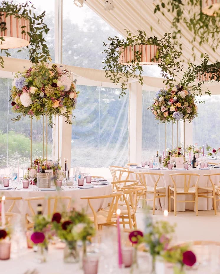 Stylish pink and floral wedding decor inside clearspan framed marquee