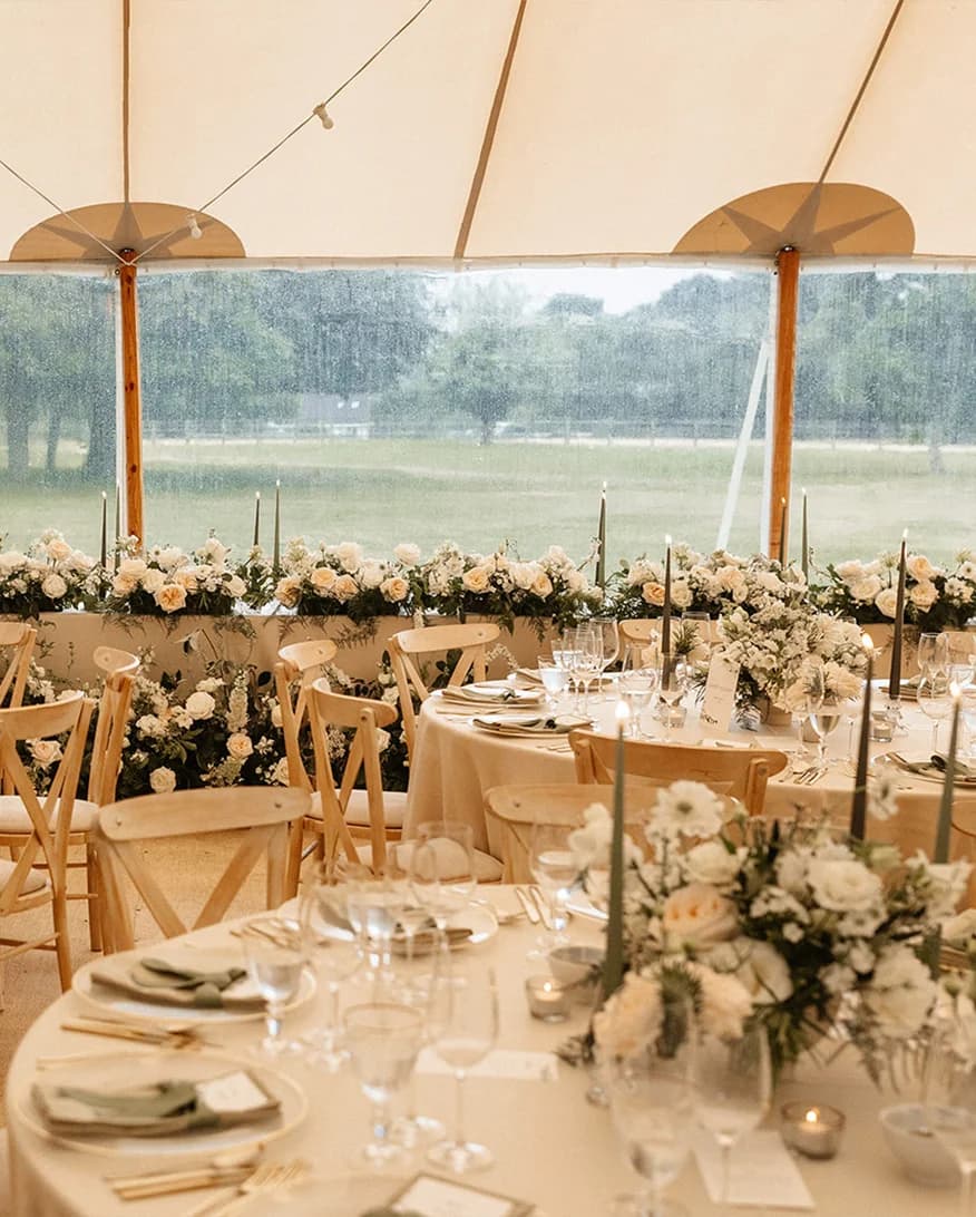 Simple and elegant floral wedding decor inside marquee