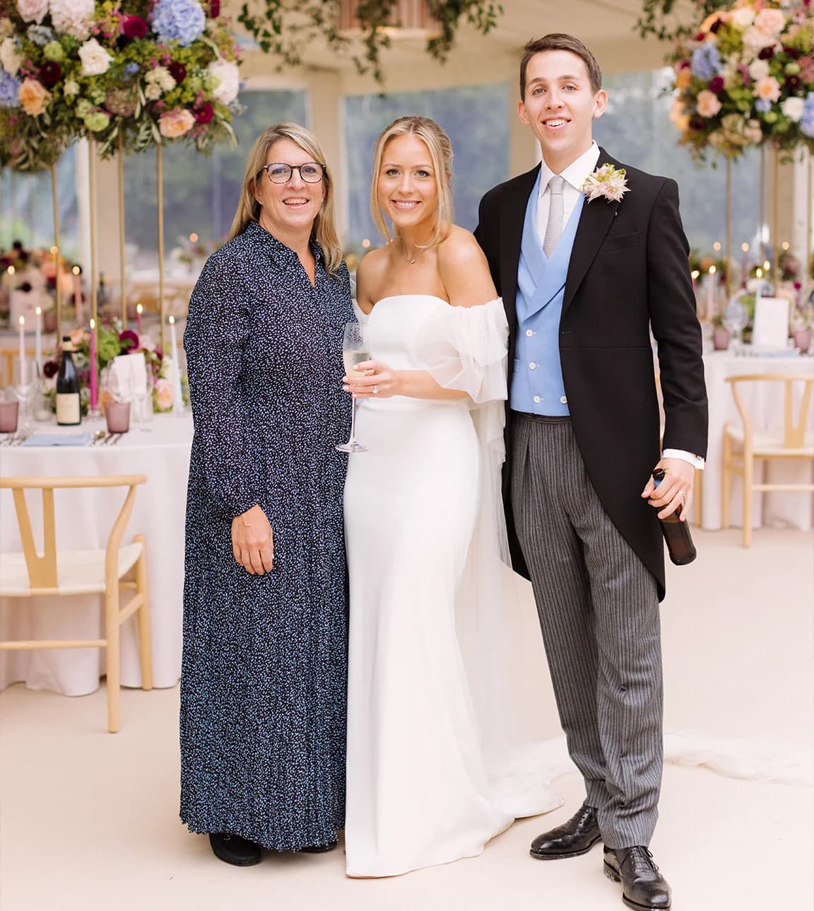 A marquee wedding planner Susie Evans next to bride and groom