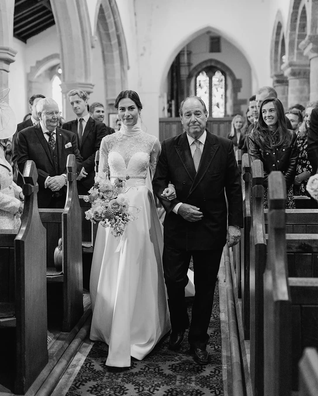 Marsha, the bride, being walked down the aisle by her father