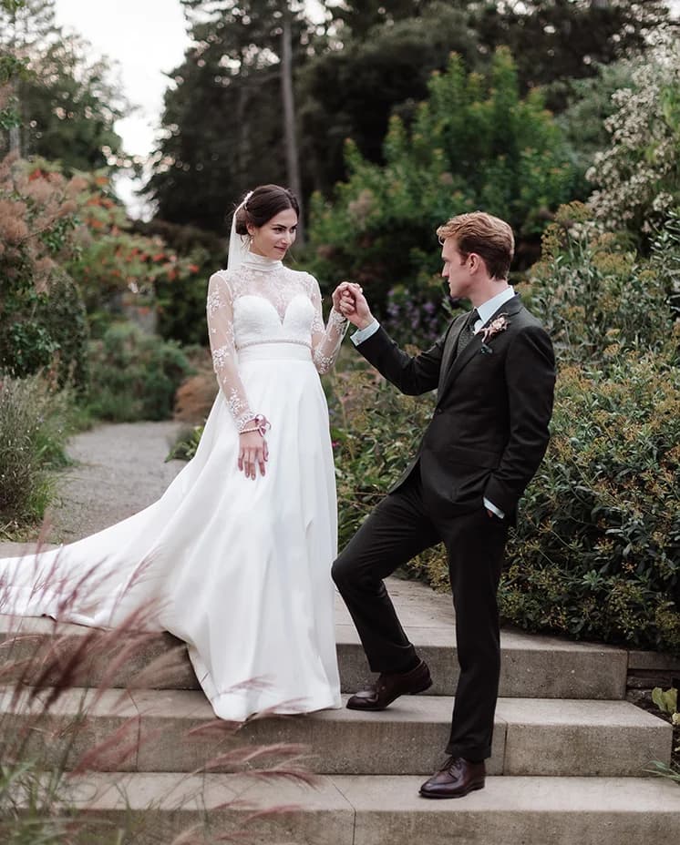 Bride and groom walk in the gardens of Middleton Lodge