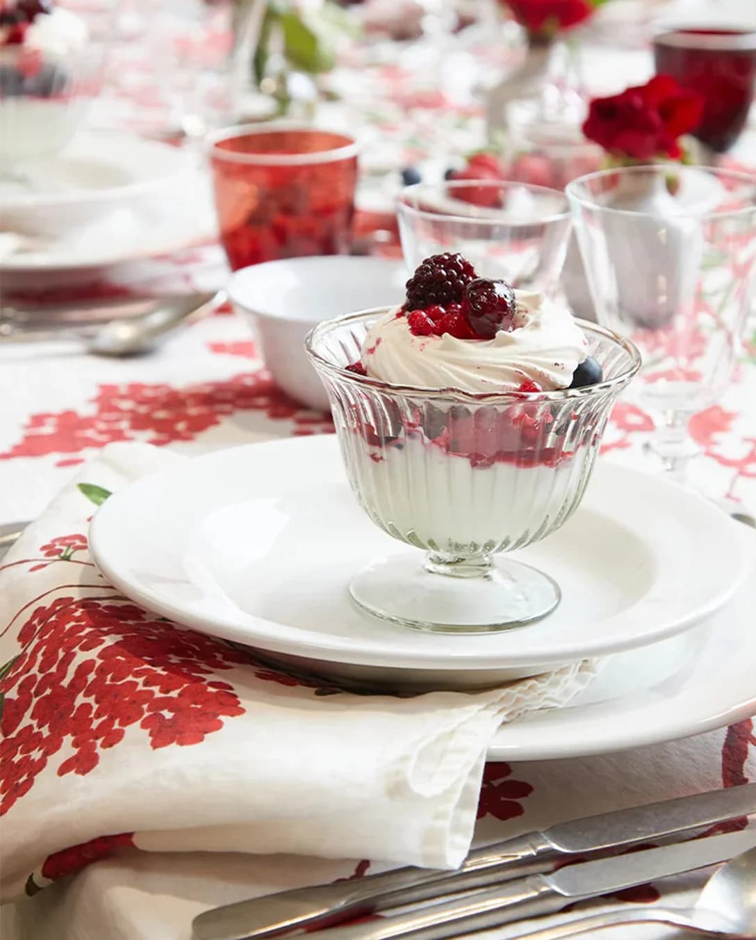 A Christmas themed napkin under plate with festive dessert