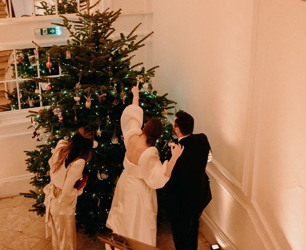 Bride and groom are checking Christmas tree at Belgravia