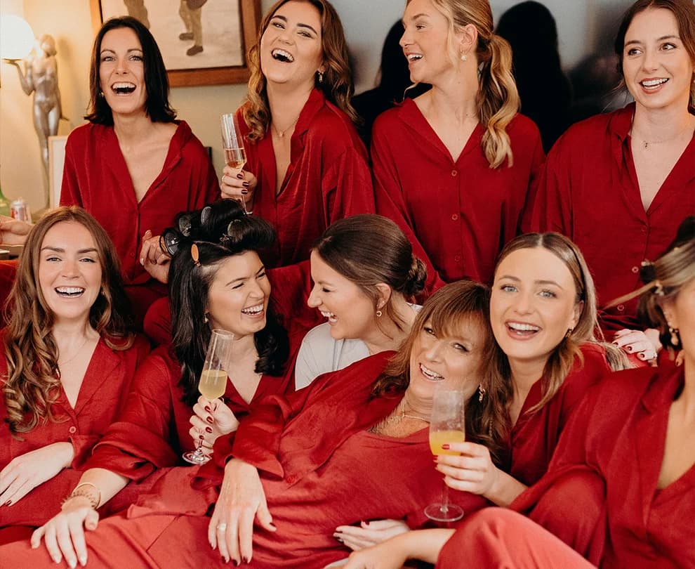 Bride and bridesmaids wearing matching pyjamas in rust colour