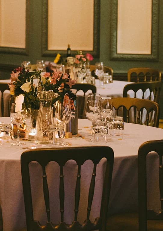 Romantic wedding reception table at Kingswood House with floral centrepieces, candlelight, and elegant place settings.