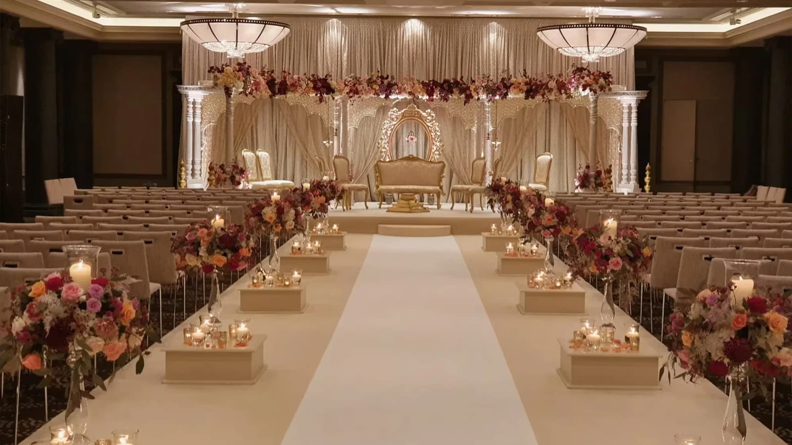 Rosewood London wedding venue ceremony setup with flower-lined aisle, candles, and grand ballroom décor