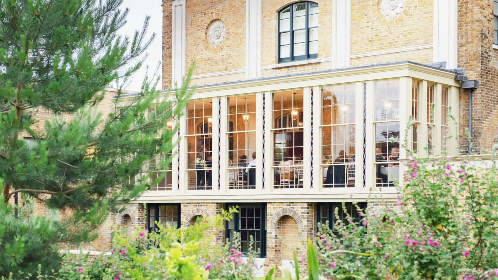 Wedding reception at Pitzhanger Gallery & Manor London conservatory with glass walls and garden views