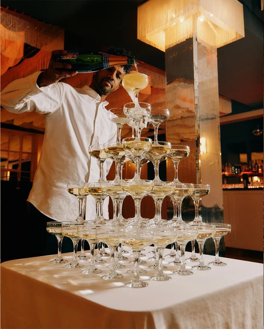 Bistroteque London wedding venue champagne tower with pouring champagne and luxury reception detail