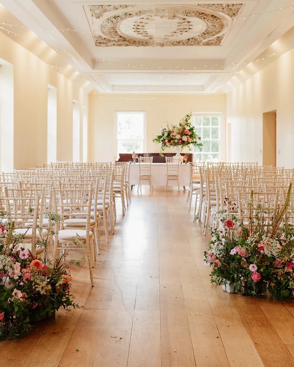 Wedding ceremony at Lauderdale House Camden London with floral aisle décor, elegant seating, and light-filled interior
