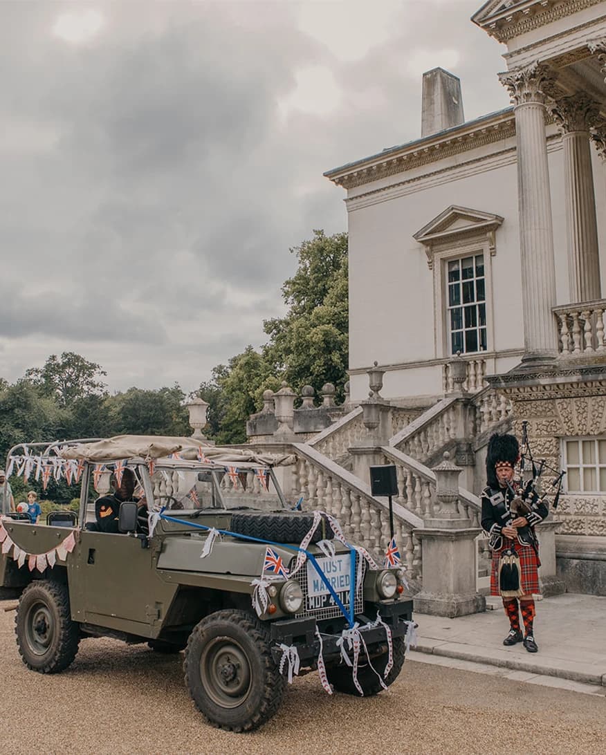 Chiswick House and Gardens wedding London with decorated jeep, bagpiper, and grand neoclassical exterior
