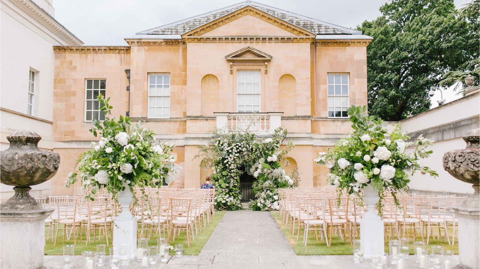 Outdoor wedding ceremony at Chiswick House and Gardens London with floral aisle and elegant historic backdrop