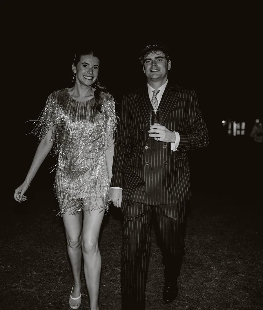 Bride in an Annie's Ibiza tassel dress and groom in a navy pinstripe Gieves & Hawkes suit