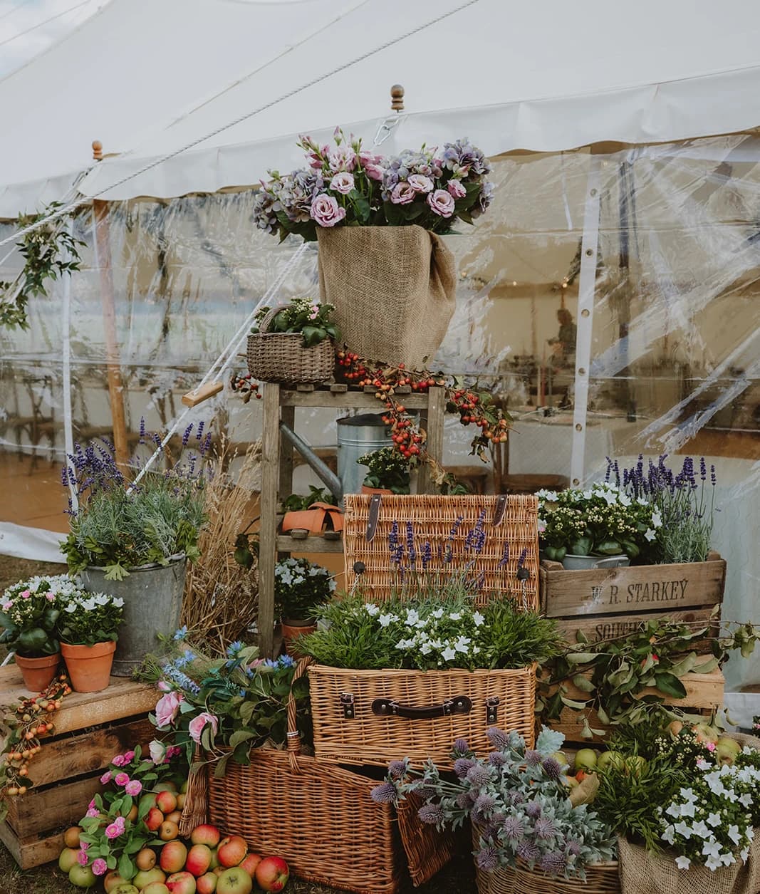 Wicker baskets, apple crates and lavender pots arranged at the marquee entrance